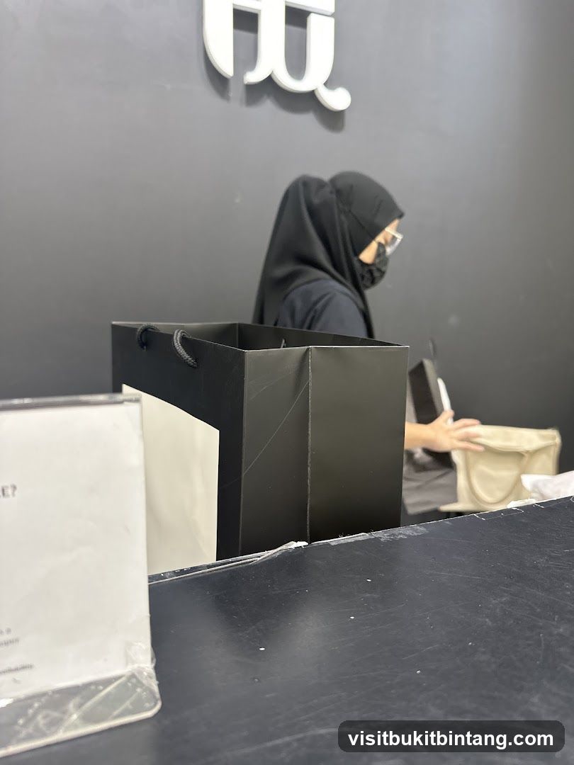 Shopping bags and a person at a counter