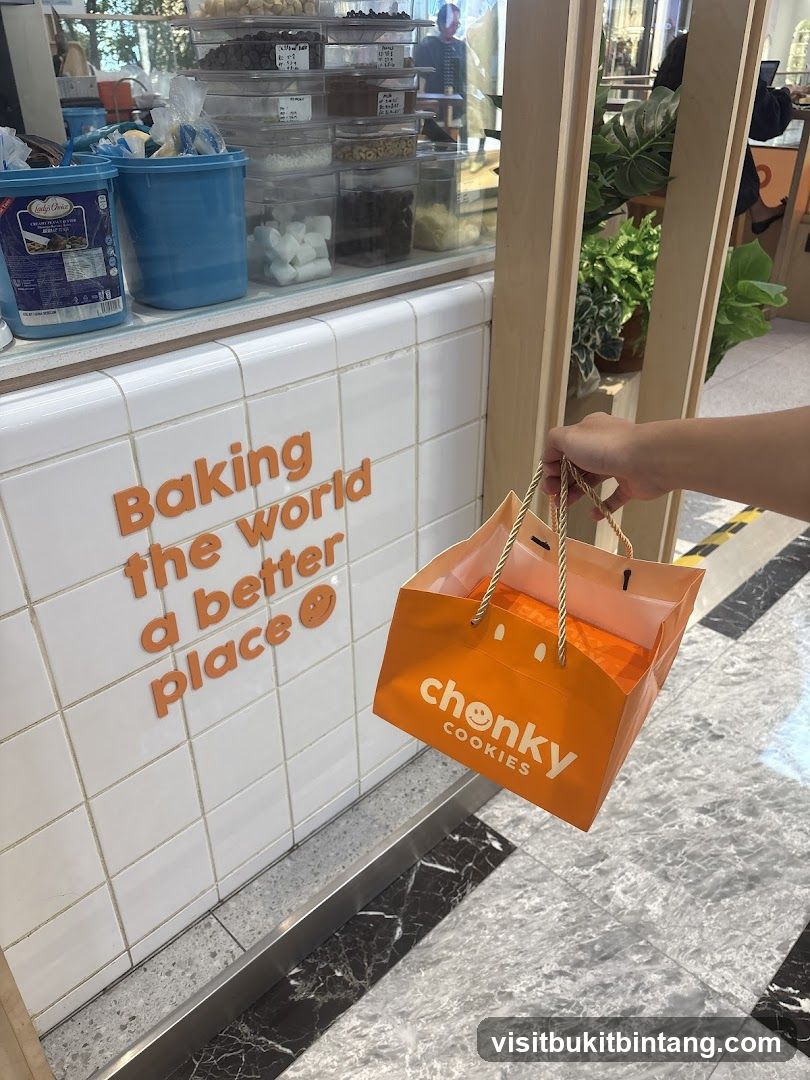 Person holding a shopping bag with cookies