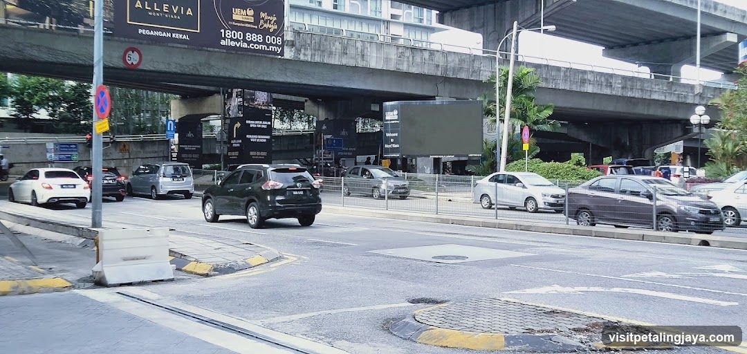 Urban street scene with vehicles and billboards