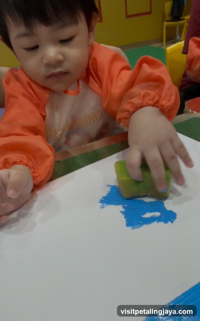 Child Painting with Sponge