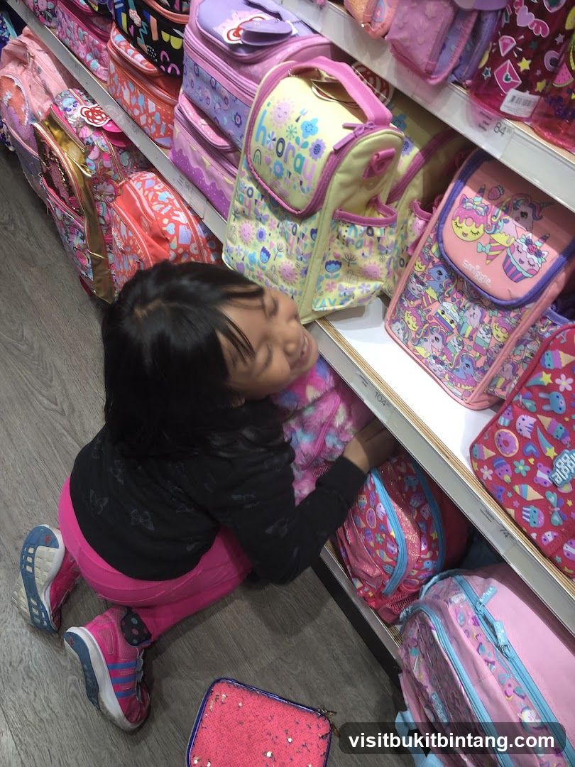 Girl Looking at Backpacks