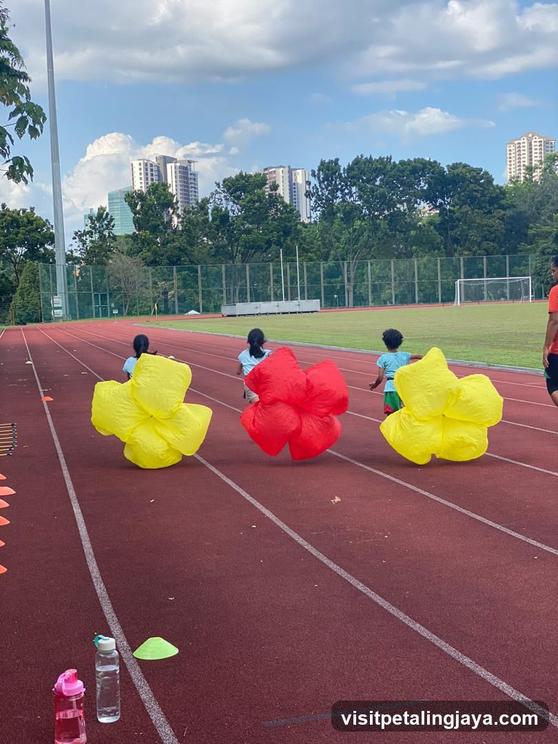 Children Running with Inflatable Flowers on Track