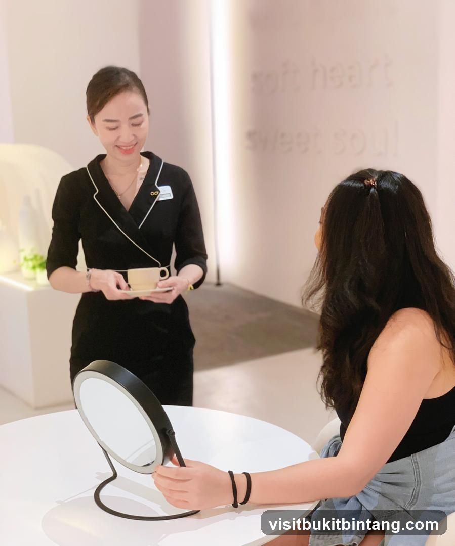 Spa attendant serving tea to a client