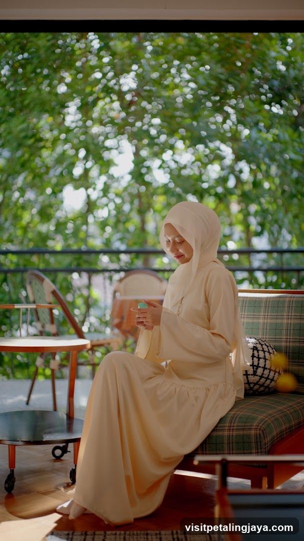 Woman in Cream Abaya on Balcony