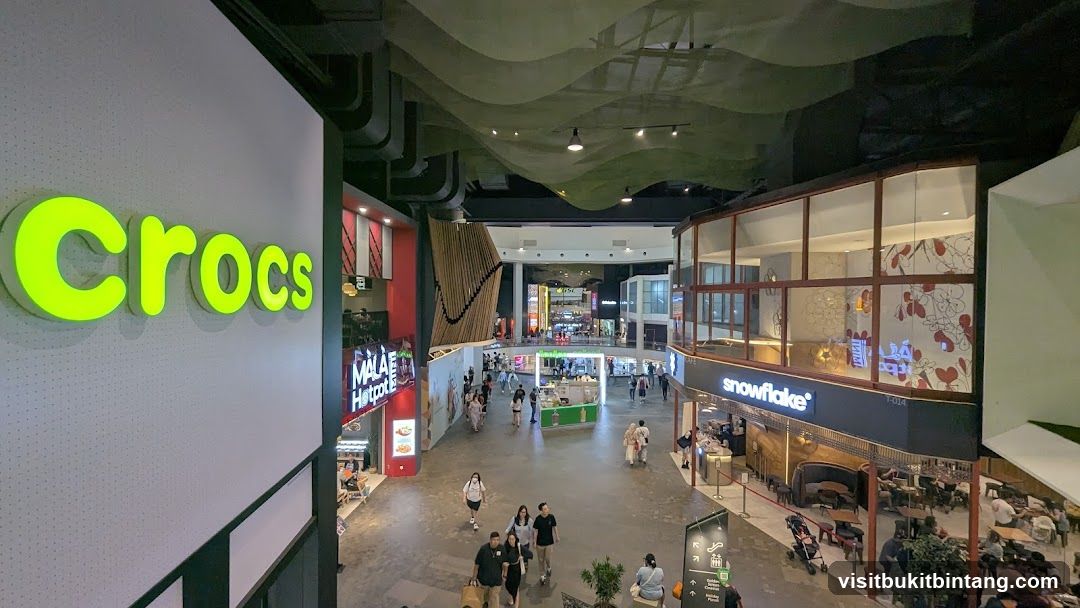 Indoor shopping mall with various stores and people