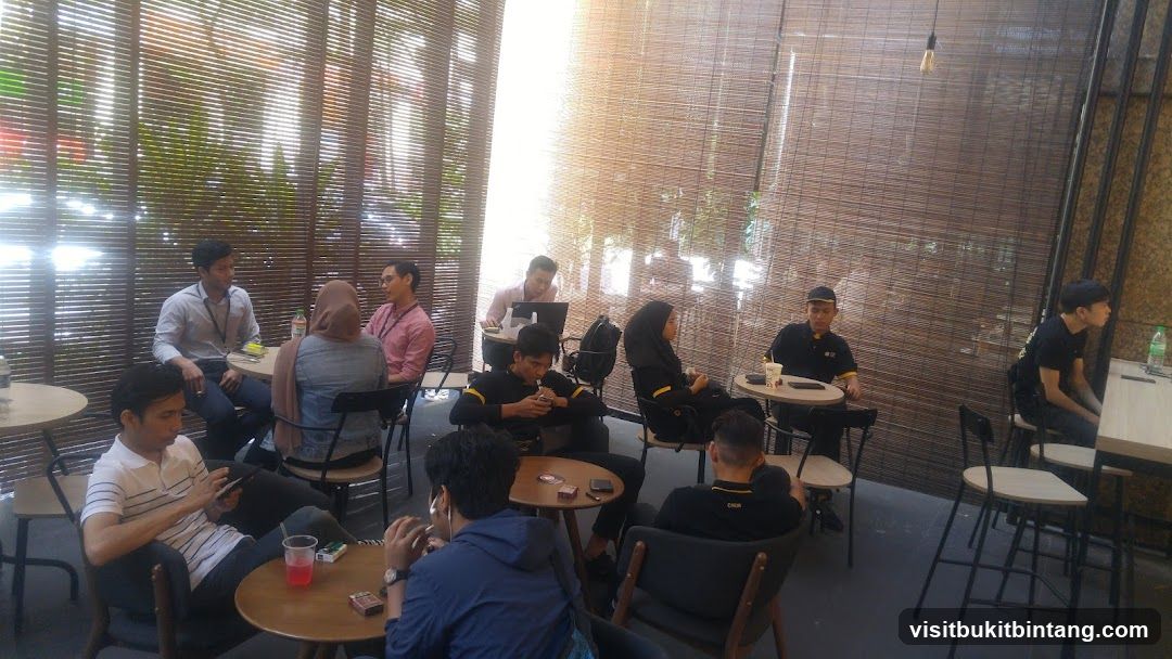 People sitting at tables in a cafe