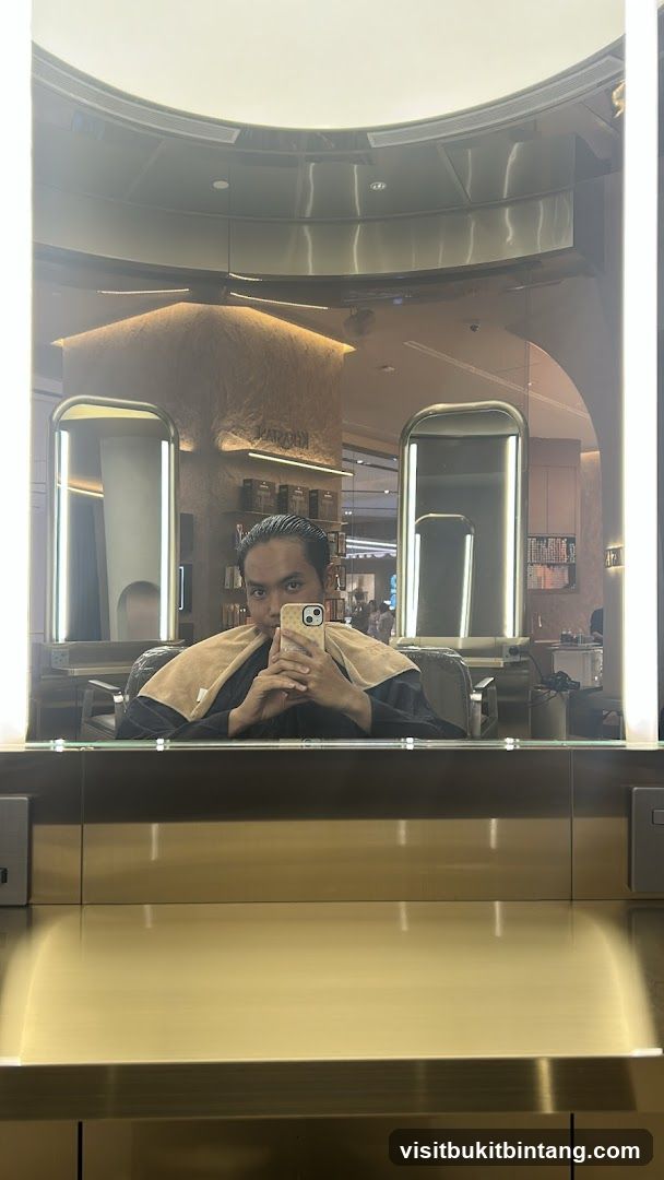 Man taking a mirror selfie in a salon