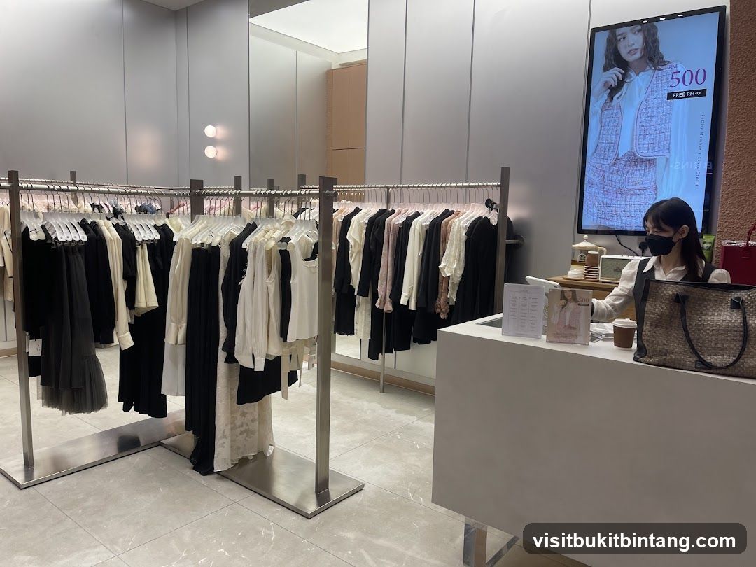 Clothing store interior with racks of clothes and a cashier