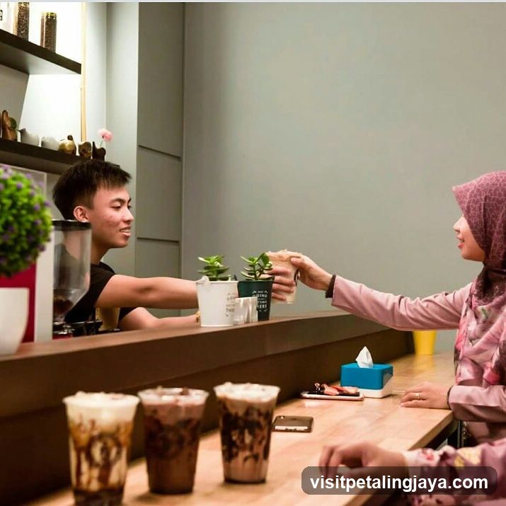 Barista Handing Coffee to Customer