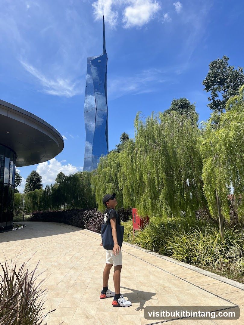 Boy looking up at a modern skyscraper