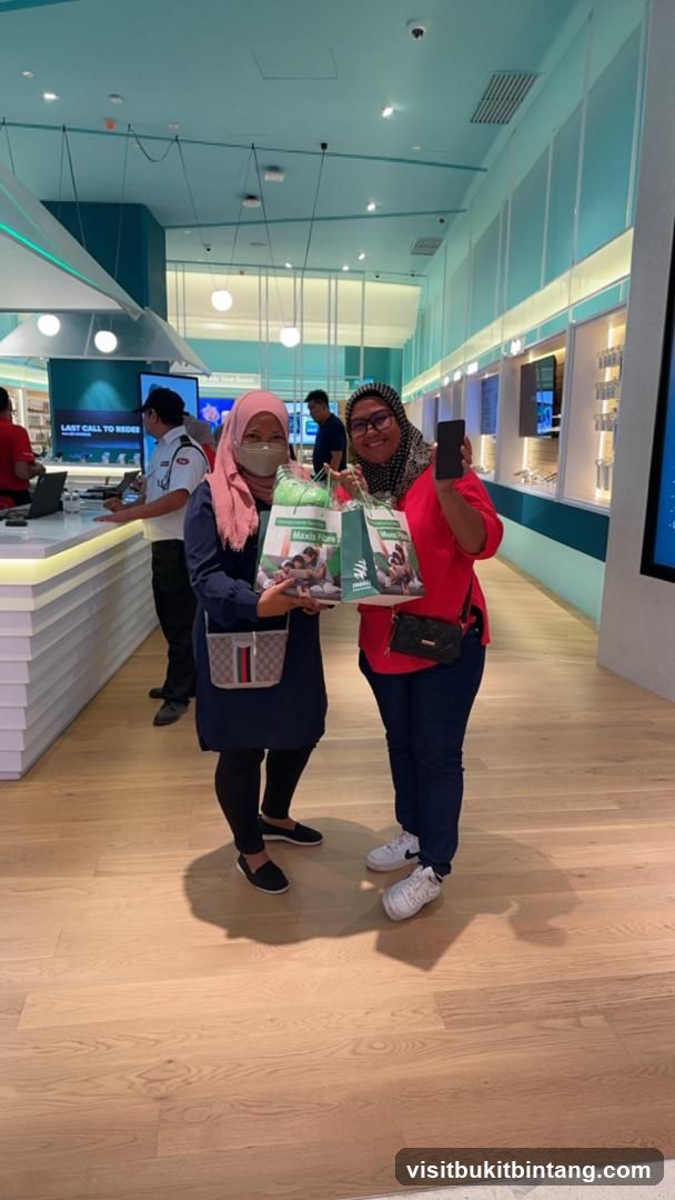 Two women holding shopping bags and a phone
