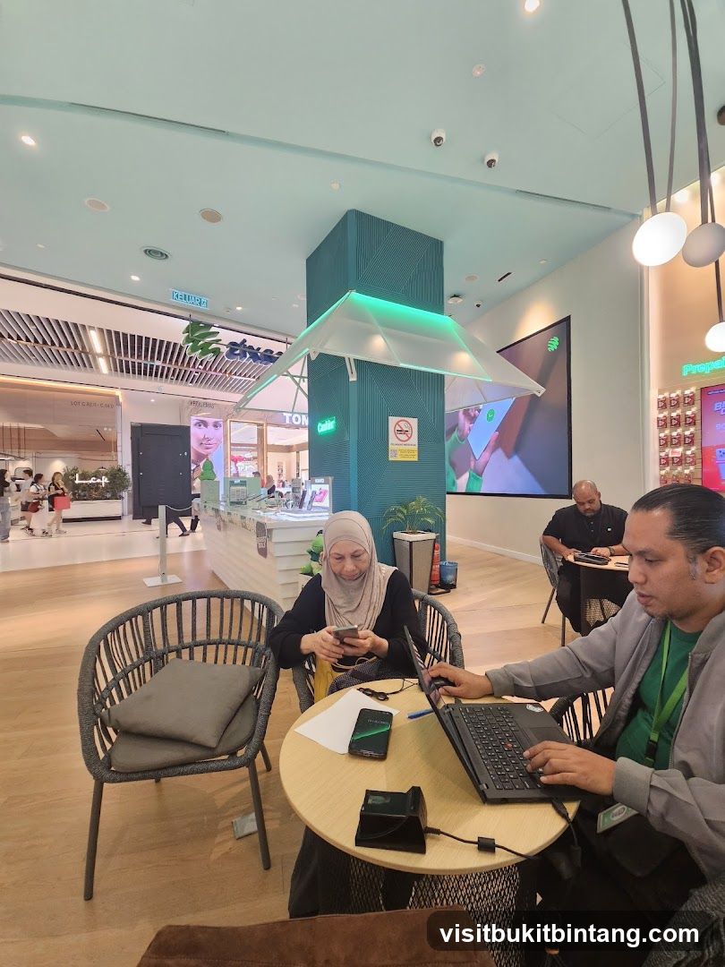 People using phones and laptops in a modern cafe