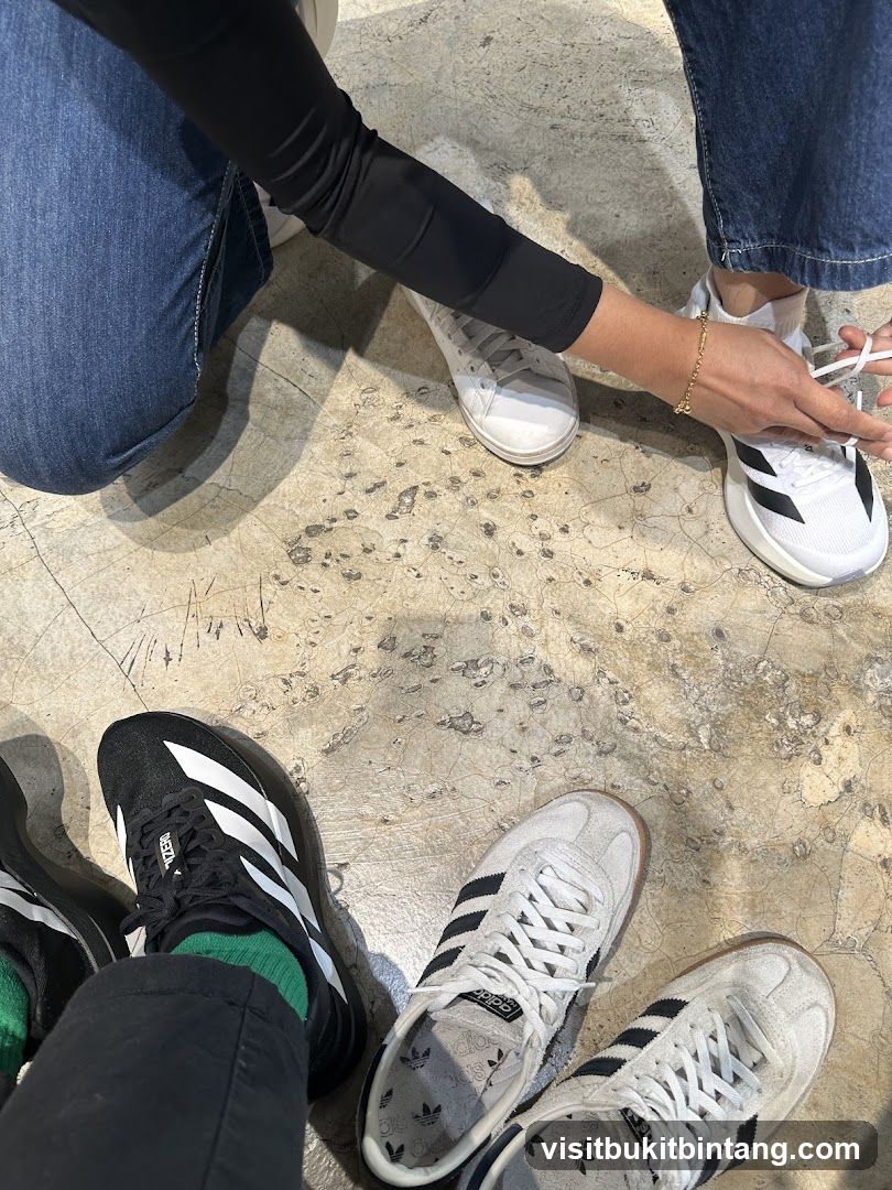 People trying on Adidas shoes
