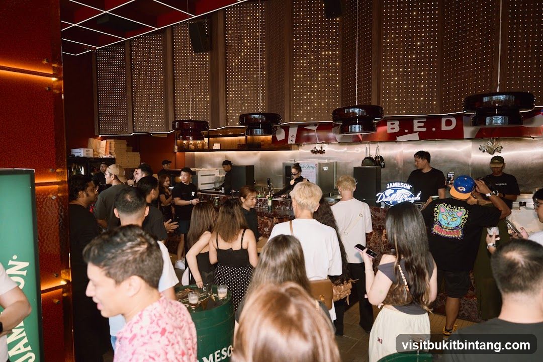 People gathered at a bar with a DJ