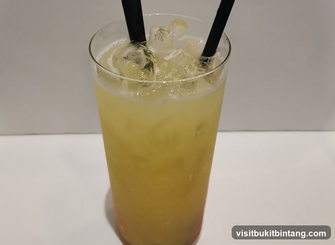 Yellow Cocktail with Ice and Straws