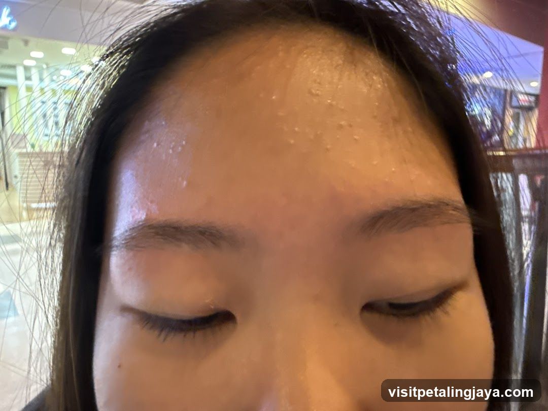 Close-up of forehead and eyes with visible sweat or moisture on skin