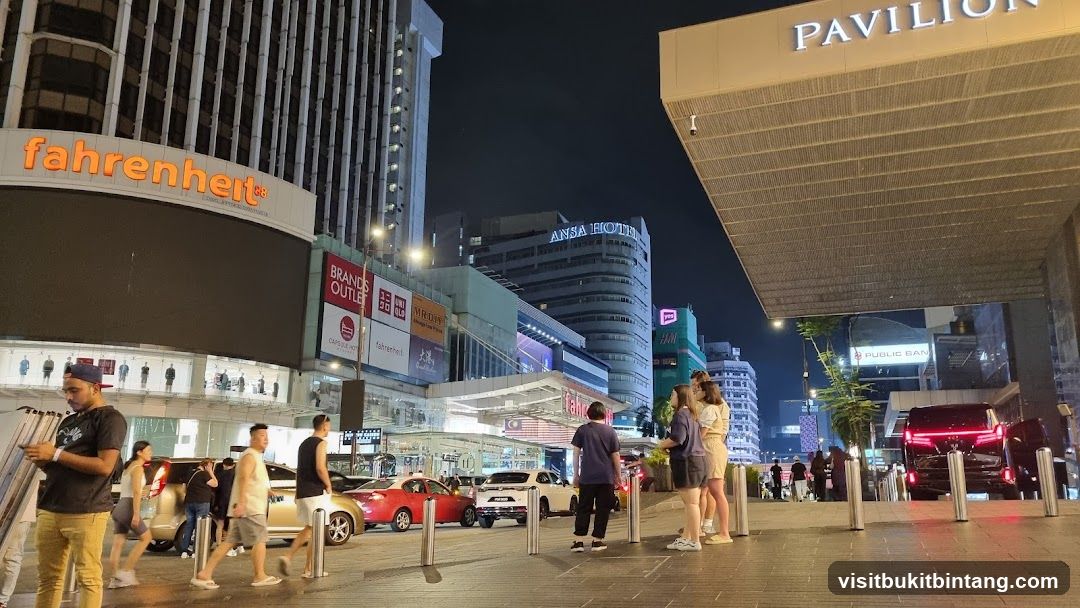 Night view of a busy street with shops and hotels