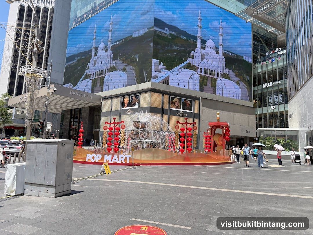Outdoor plaza with large digital screen and fountain