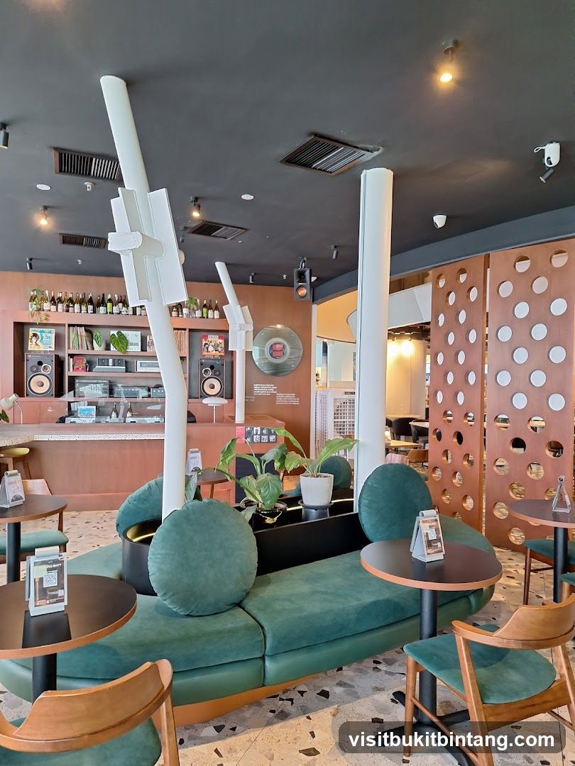 Modern cafe interior with green seating and vinyl records