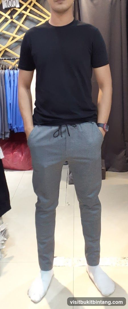 Man in black t-shirt and grey pants