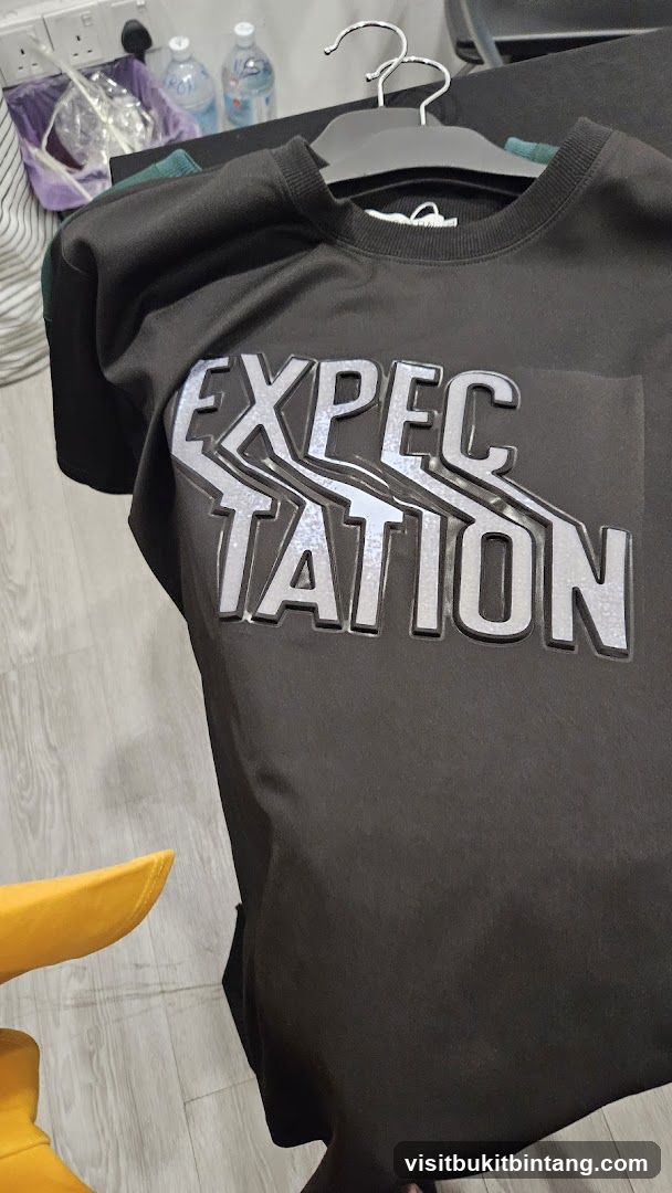 Black sweatshirt with "Expectation" graphic
