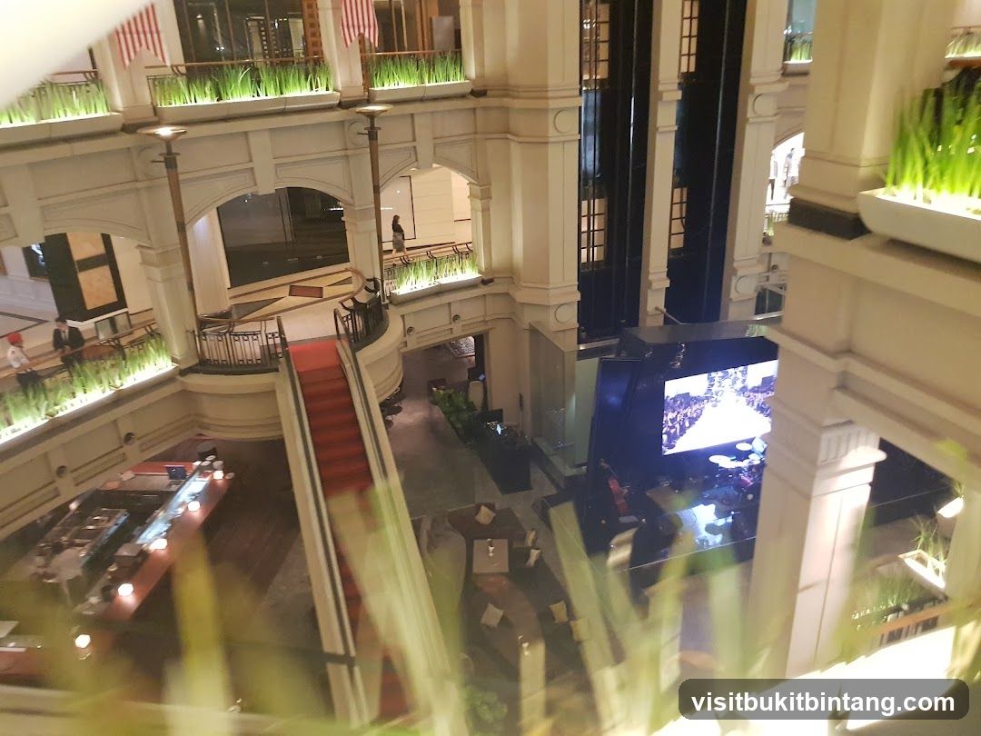 Interior of a multi-level building with a red carpeted escalator