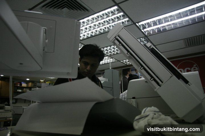 Man working with a copier