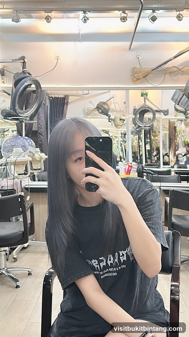 Woman taking a selfie in a hair salon