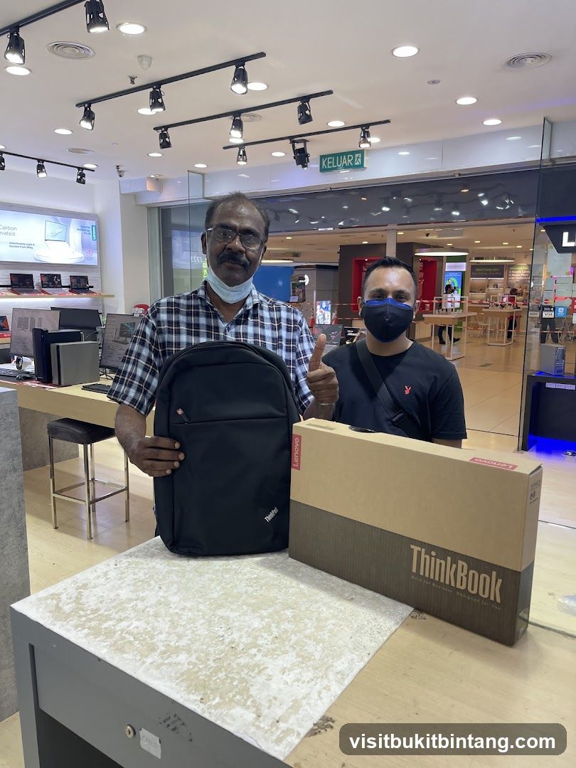 Two men with a laptop and backpack