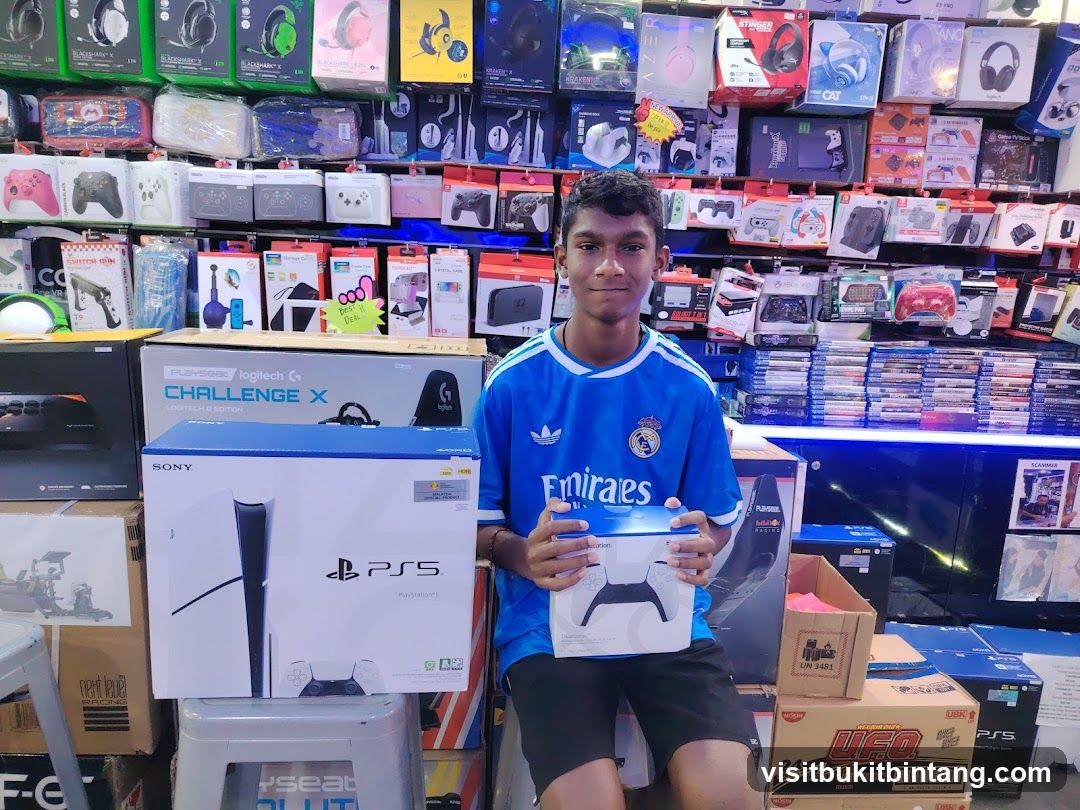 Young man holding PlayStation 5 controller box in electronics store