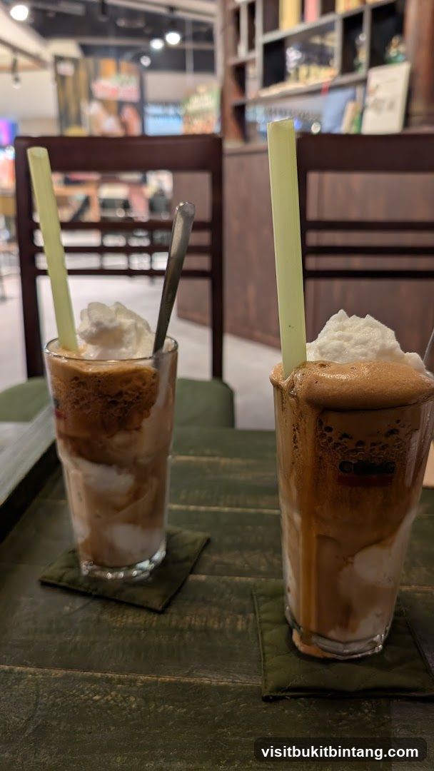 Two iced coffee drinks with whipped cream