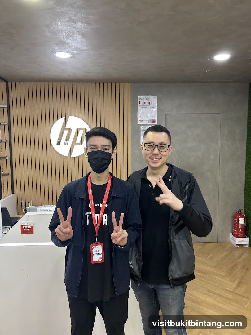 Two men posing in an HP store