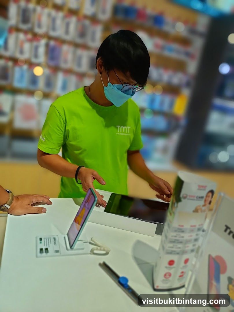 Salesperson assisting customer with a tablet