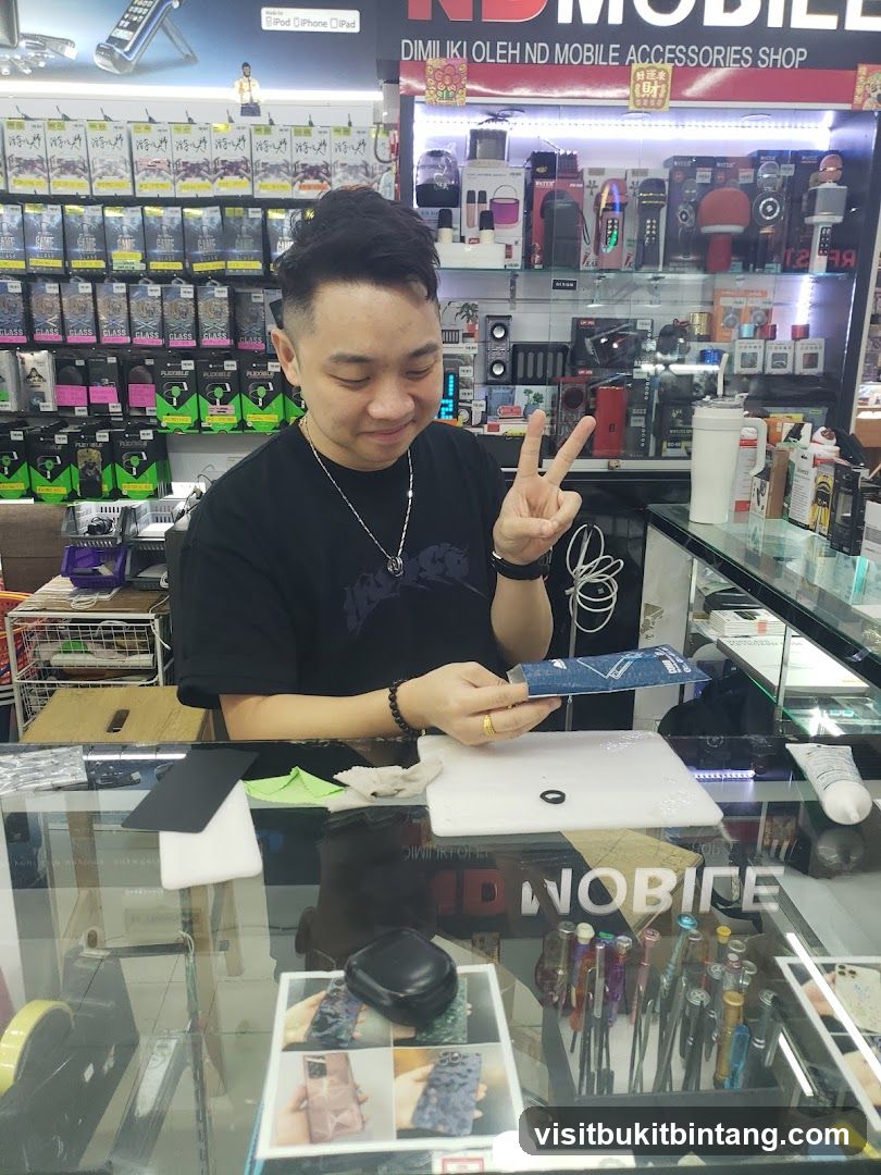 Man working at a mobile accessories shop