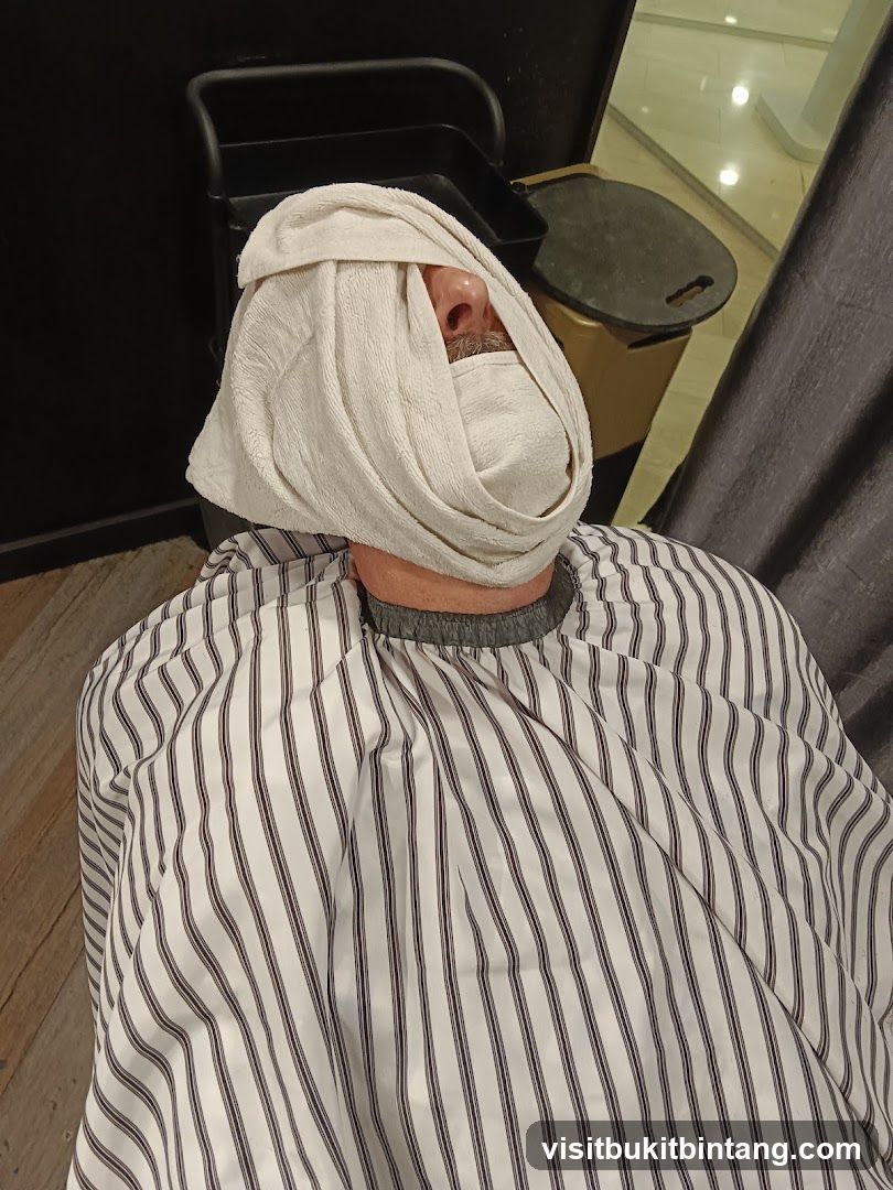 Man with towel on face