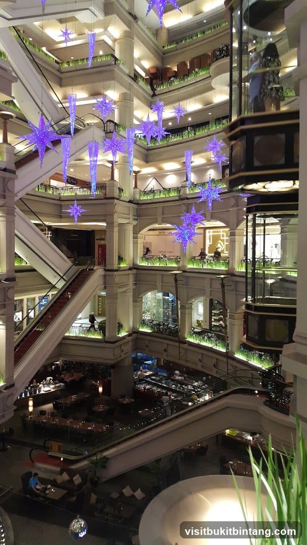 Interior of a multi-level shopping mall with festive decorations