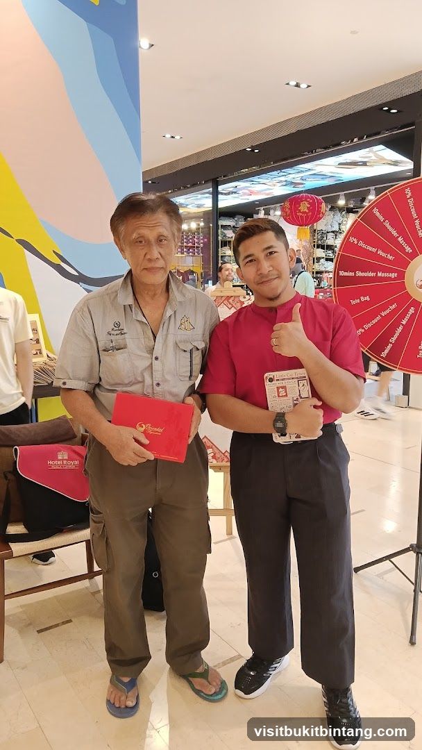 Two men posing with promotional items