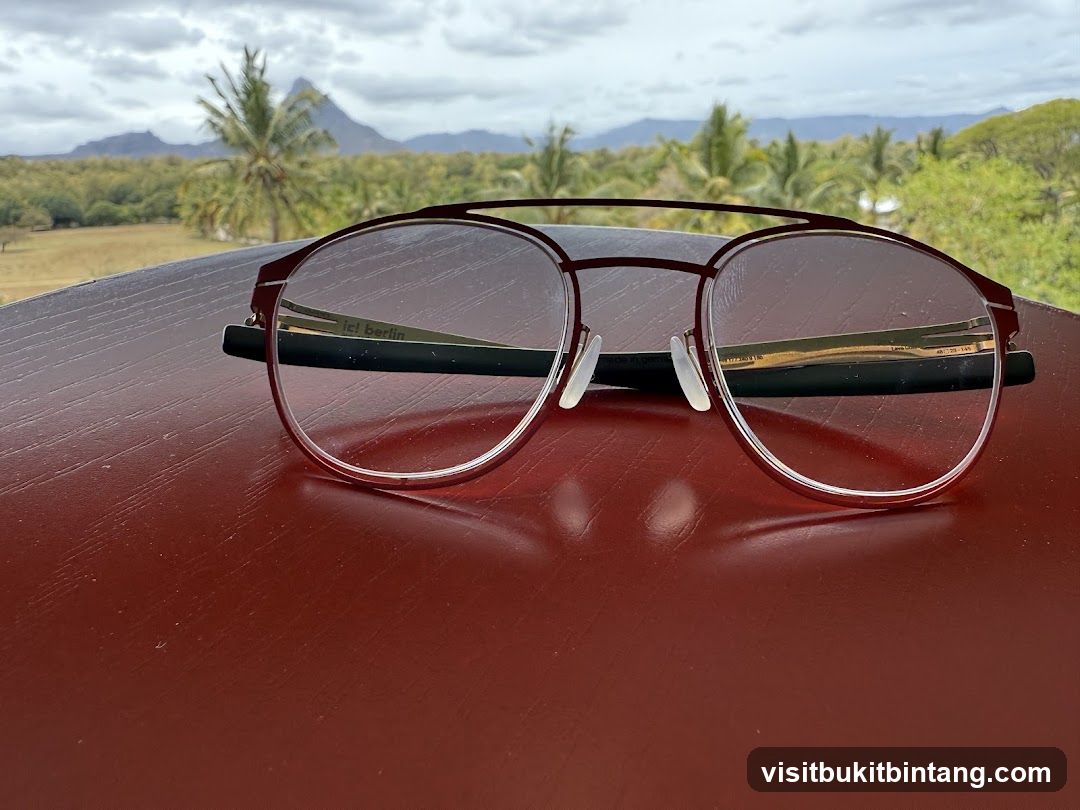 Eyeglasses on a table with a scenic background