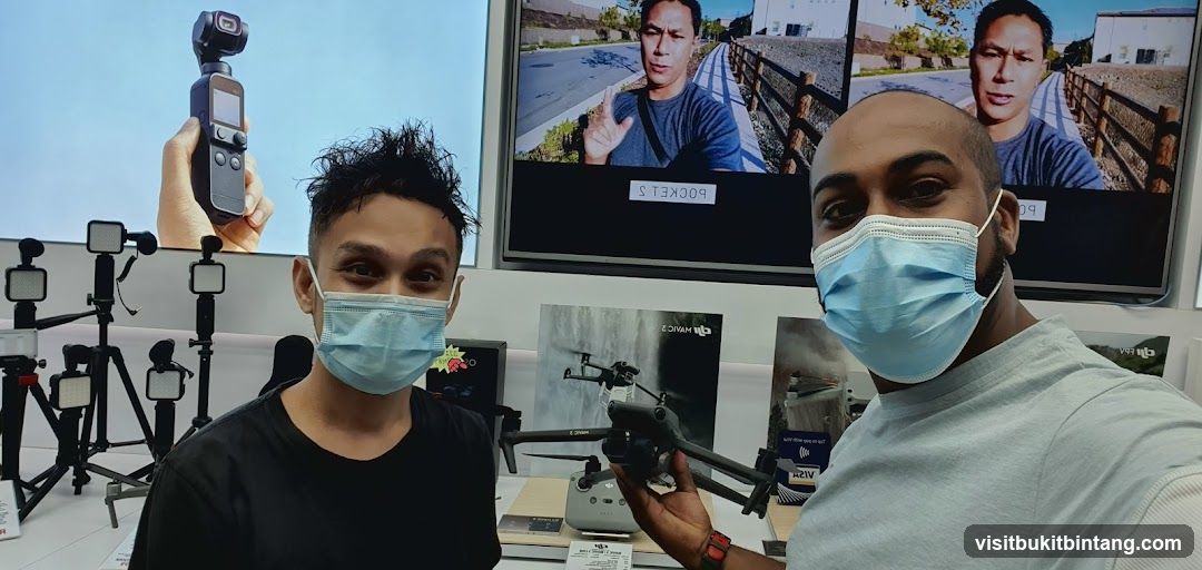 Two men in a store with drones and cameras