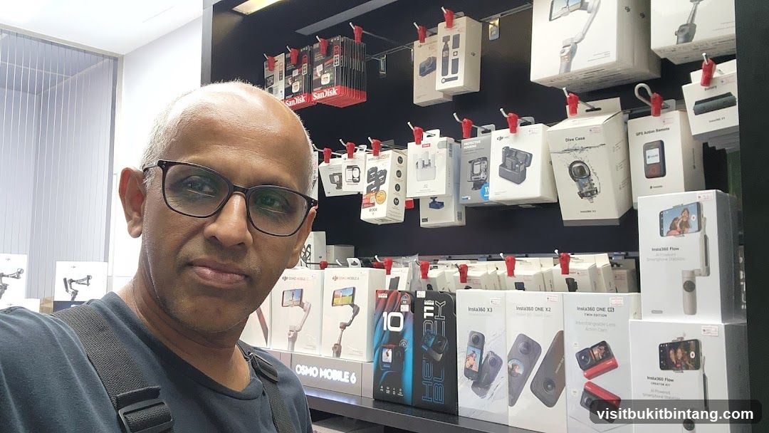 Man in Store with Camera Accessories