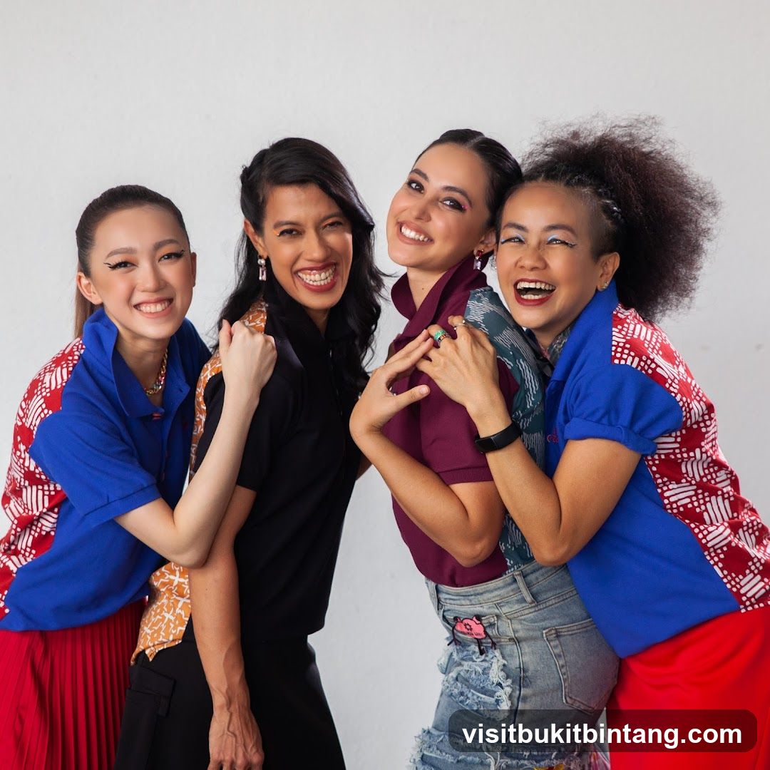 Four women smiling and posing