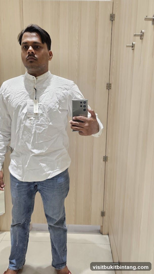 Man trying on clothes in a fitting room