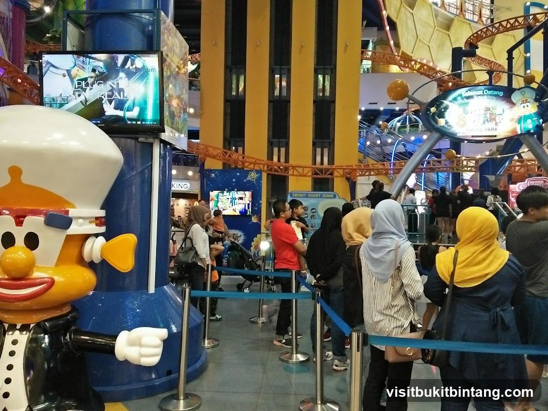 Indoor amusement park with roller coaster and cartoon character