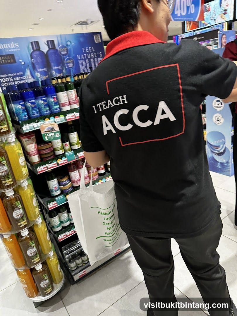 Person wearing a t-shirt with "I TEACH ACCA" printed on the back