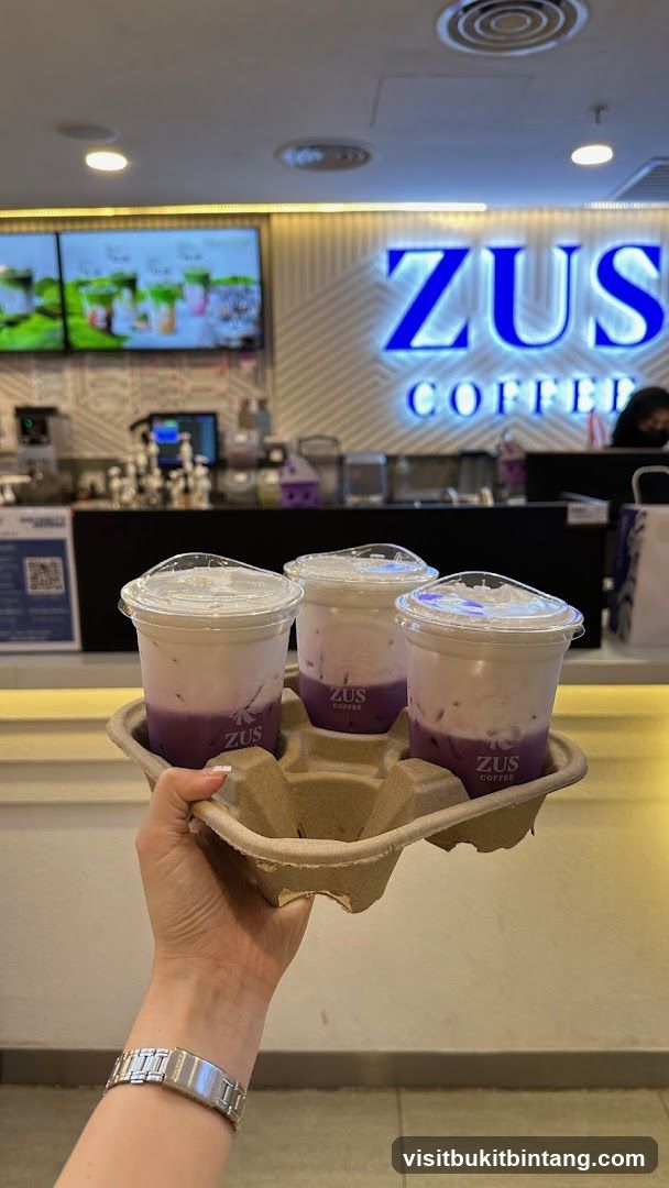 Three purple drinks in a carrier
