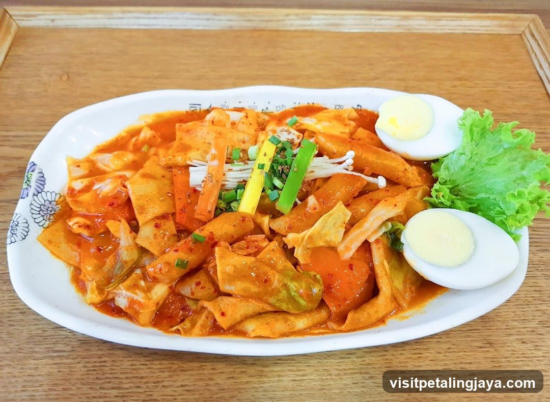 Spicy Rice Cake Dish with Boiled Egg and Greens