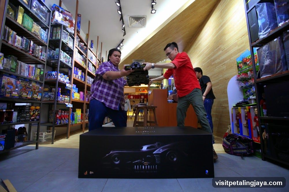 Toy Store Interior with Staff Handling Large Box