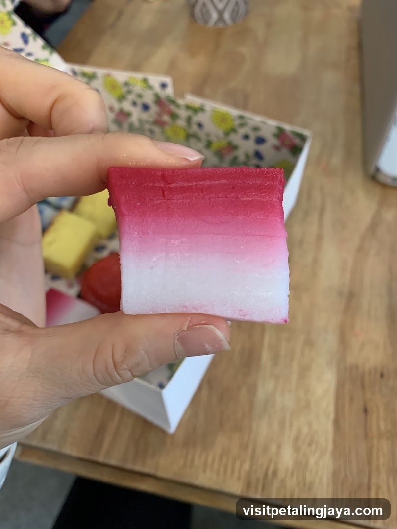 Hand holding pink and white layered soap