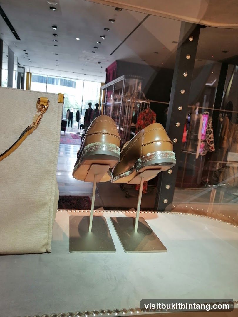 Display of brown leather loafers in a store window