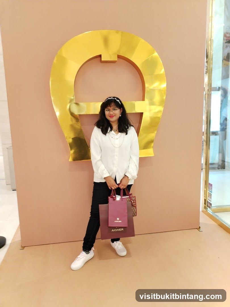 Woman Posing with Shopping Bags in Front of a Large Logo